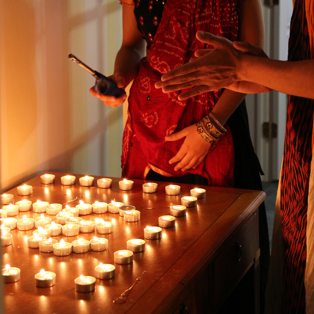 Lighting candles at Diwali celebrations