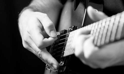 Close-up of a person playing the guitar 