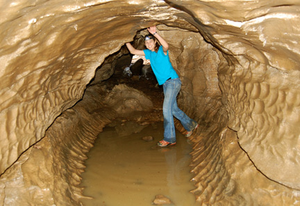 Sarah Grannemann exploring limestone dissolution features in Laurel Cave