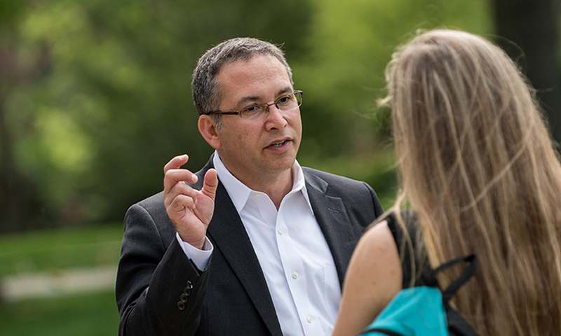 President Adam Weinberg talking to a student