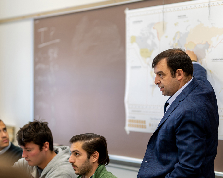 Scott Smitson in a classroom pointing at a map