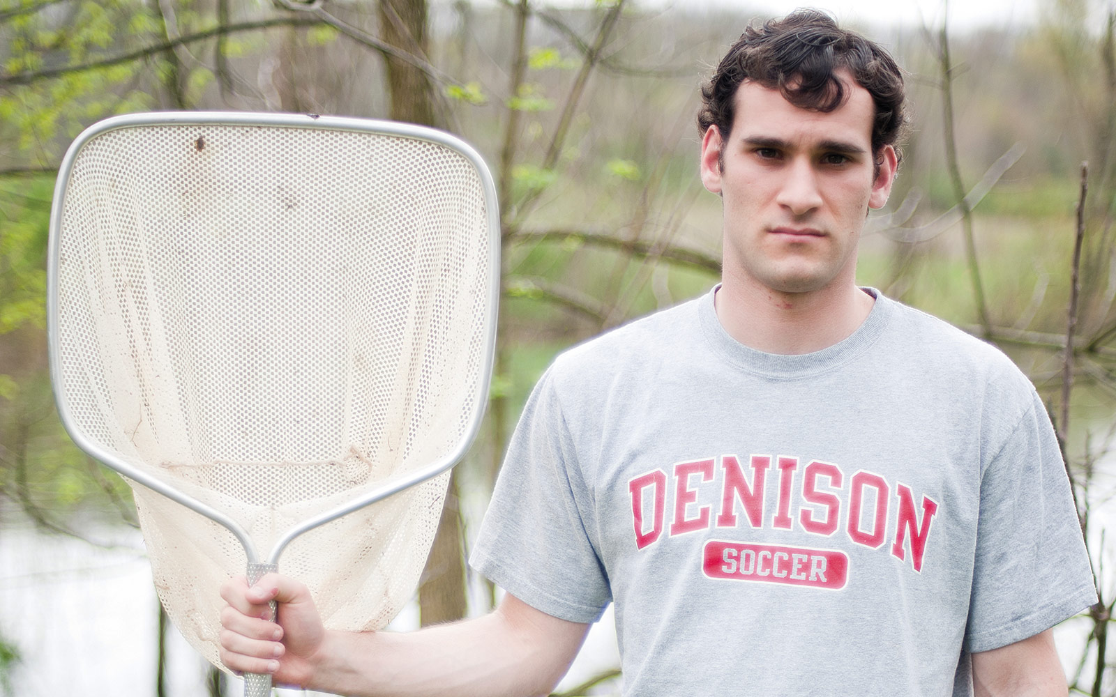 In this photo, I was going for that 'American Gothic' look. He really wanted to smile the whole time. I just liked the fishing net, the water behind him, the Denison soccer shirt. For me it kind of incorporates everything.