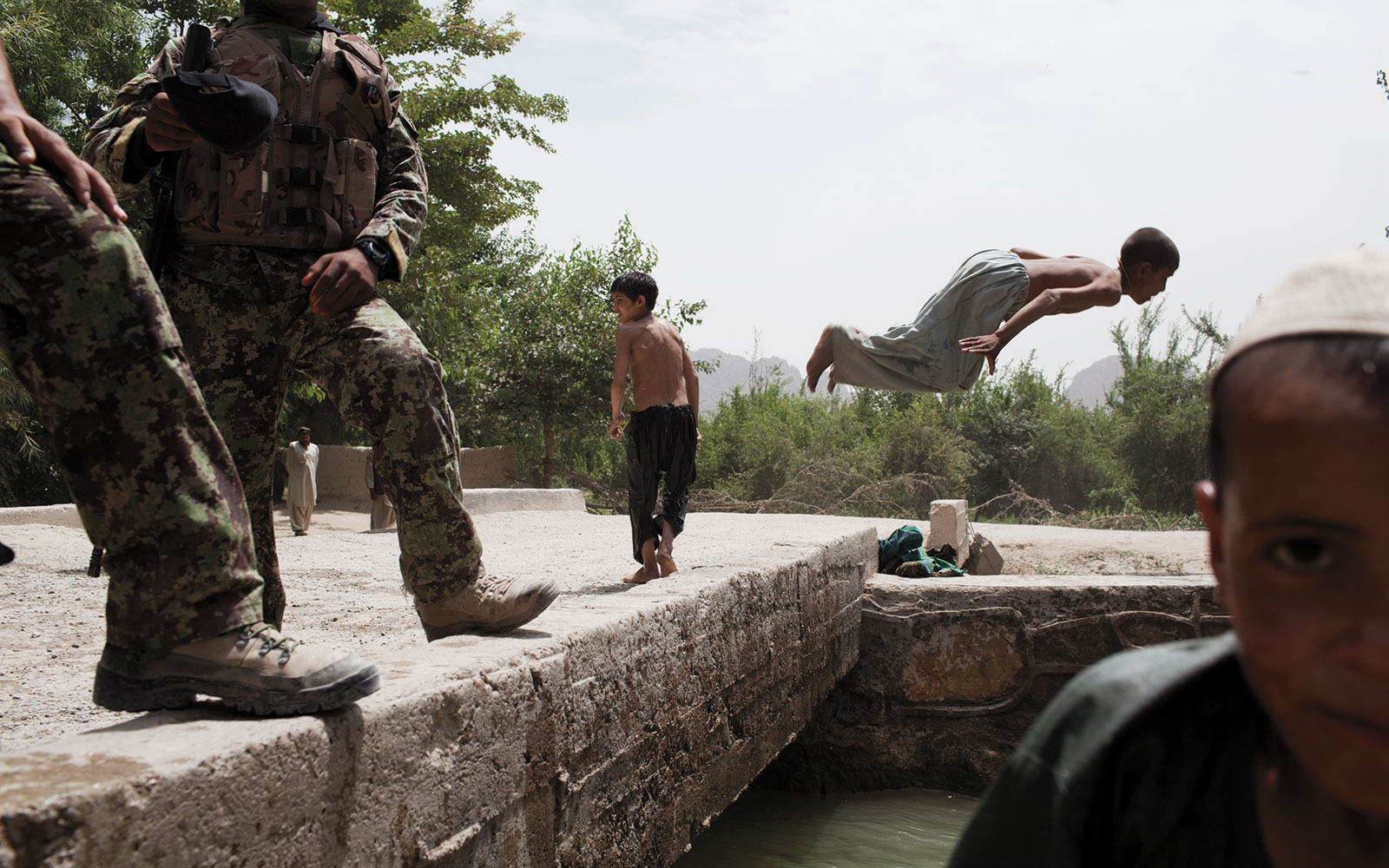 Children play in a canal outside the Tabin market, which at one point saw heavy fighting between Afghan, U.S., and NATO forces and the Taliban. Today it is safe to walk through the area.