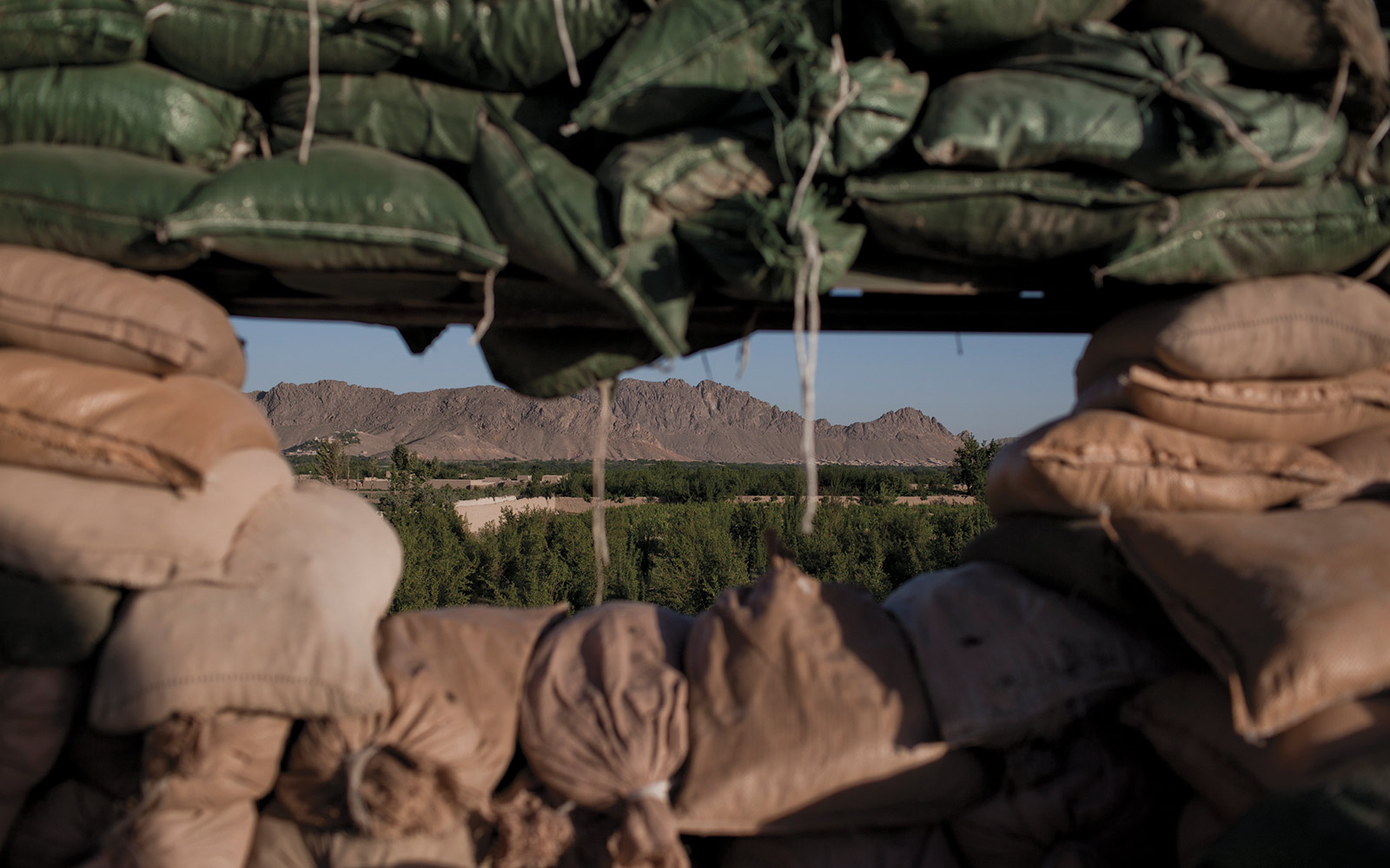 A view from behind a gun emplacement in the Arghandab River Valley in Kandahar. The embankment sits on top of a schoolhouse that had been torched by the Taliban.