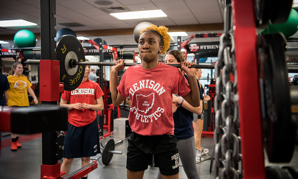 Student lifting weights in the Mitchell center - Now