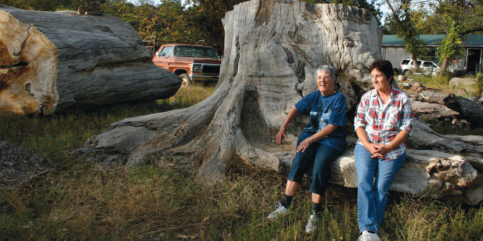 Today, Holaday remains friends with landowners whom she once feared as adversaries. Here, she lounges in an ancient cottonwood stump with Jerrie Cline Tipton, the daughter of Pat and Raymond Cline, who used to take Holaday on hours-long hor…