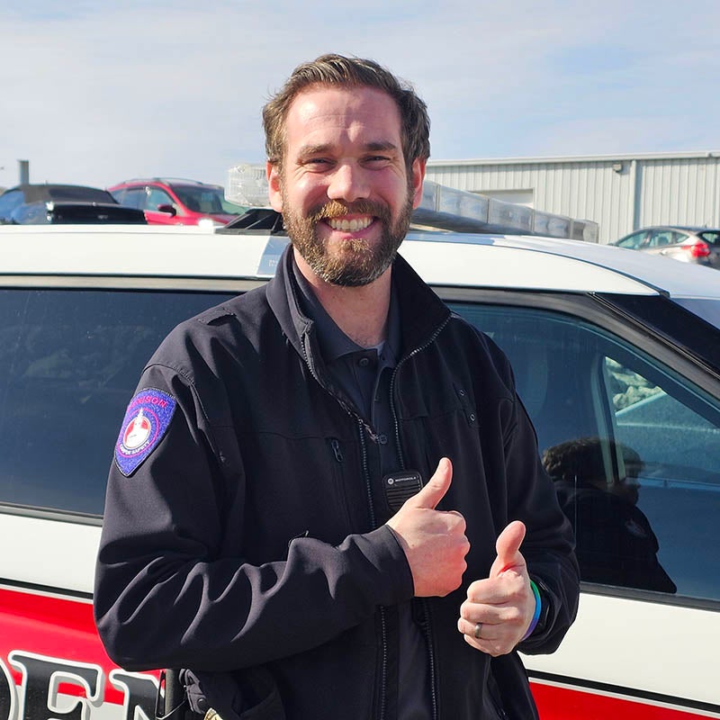 Daniel Doan stands by a Denison security vehicle.