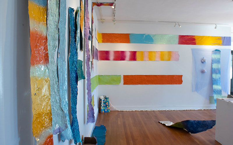 Colorful strips of Art displayed on two walls