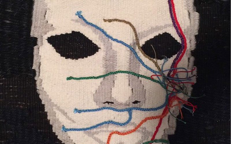 Art piece of a face with colored string spreading across it