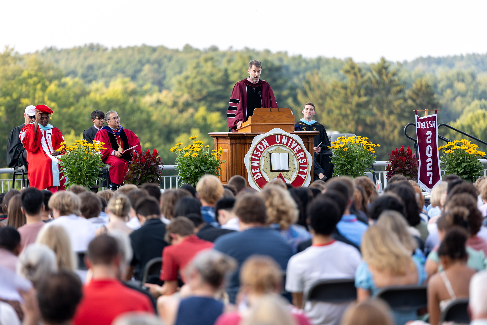 Man speaking to a crowd of new students at Induction