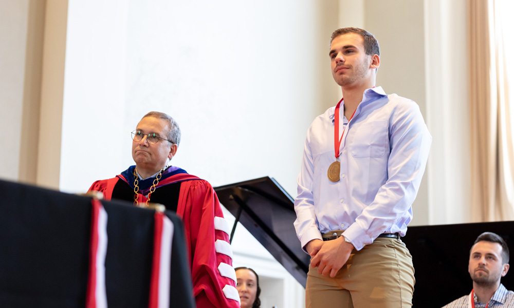 Max Sternberg ’22 listens as the achievements of his academic career are read aloud.