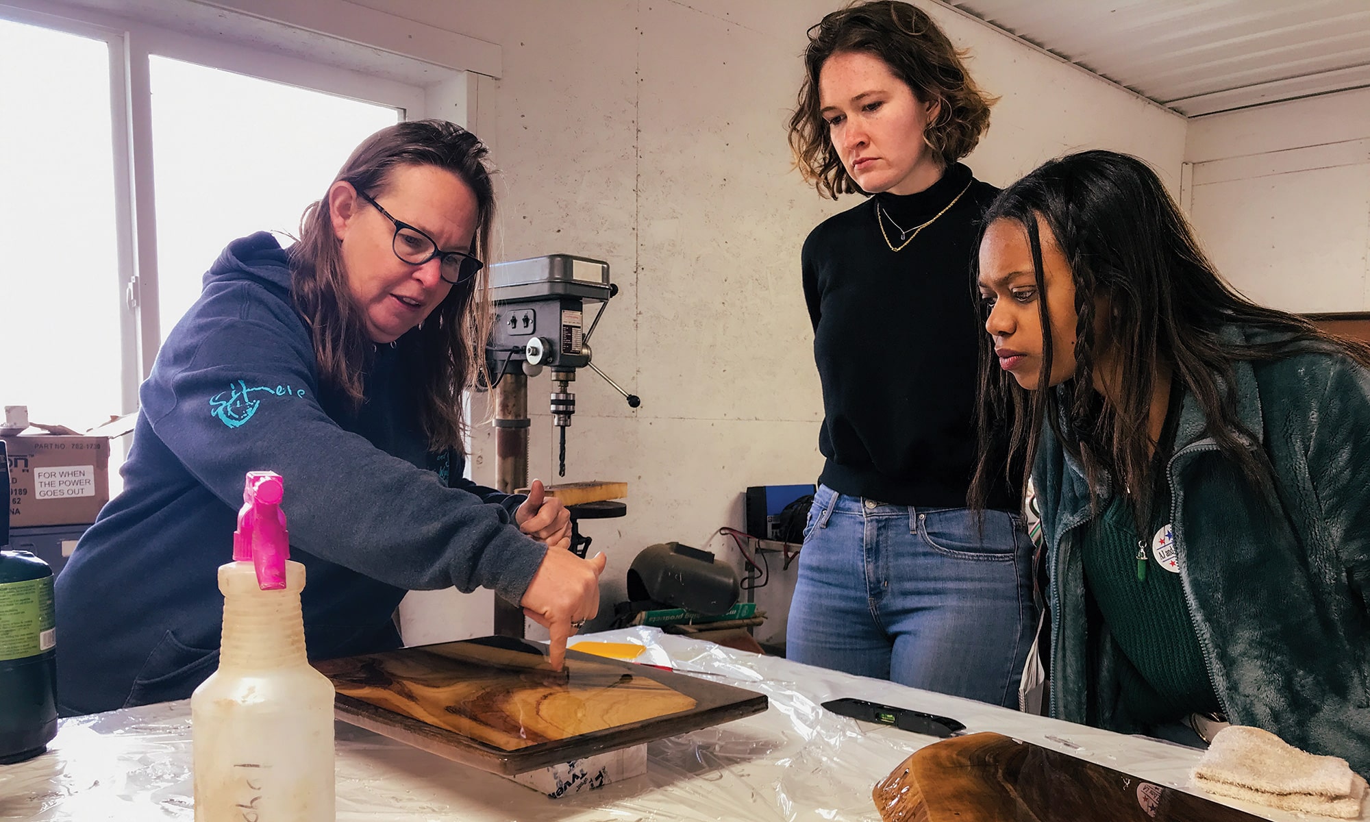 ON ASSIGNMENT: Boirard and Jen Clancey ’23 tour Sand and Sip Rustic Wood Workshop in Johnstown, Ohio, with one of its owners, Amy Kent.