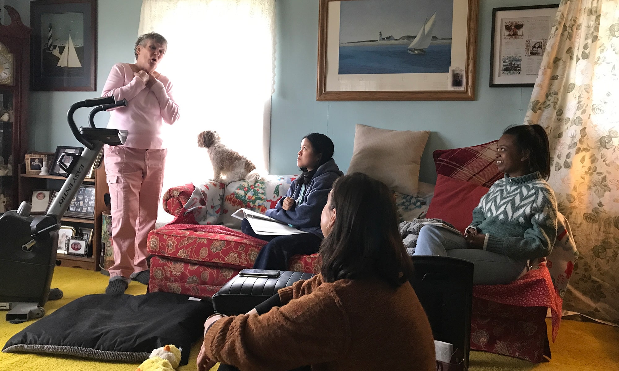 BEARING WITNESS: Standing in her living room, Vanhoose shares her feelings about the Intel project with (from left) Pol Le ’25, Molly Born, and Faith Boirard ’25.