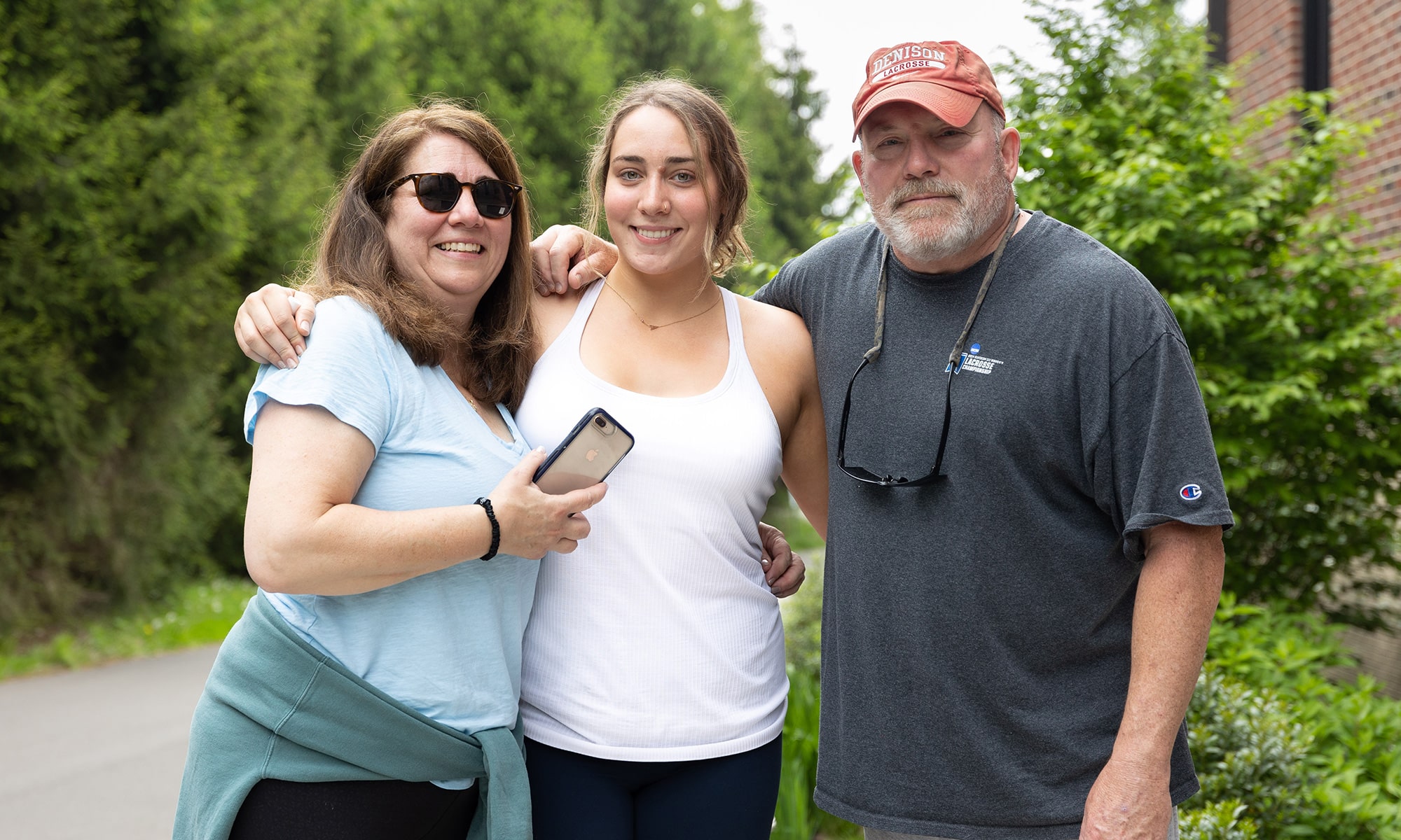 Alexis Coleman, standing between parents, Cathy and Jim