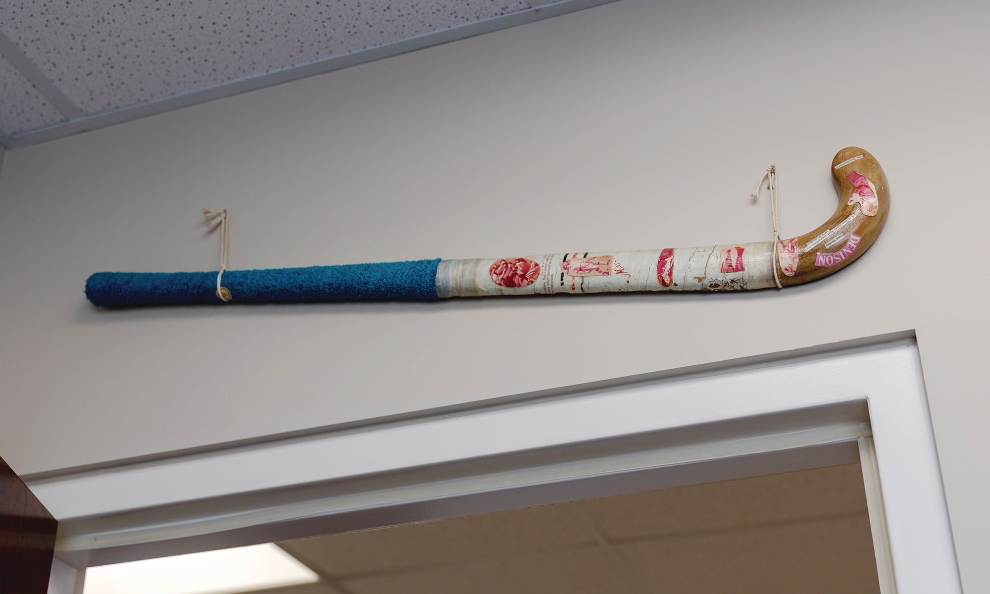 The 40-year-old field hockey stick hanging over her doorway.