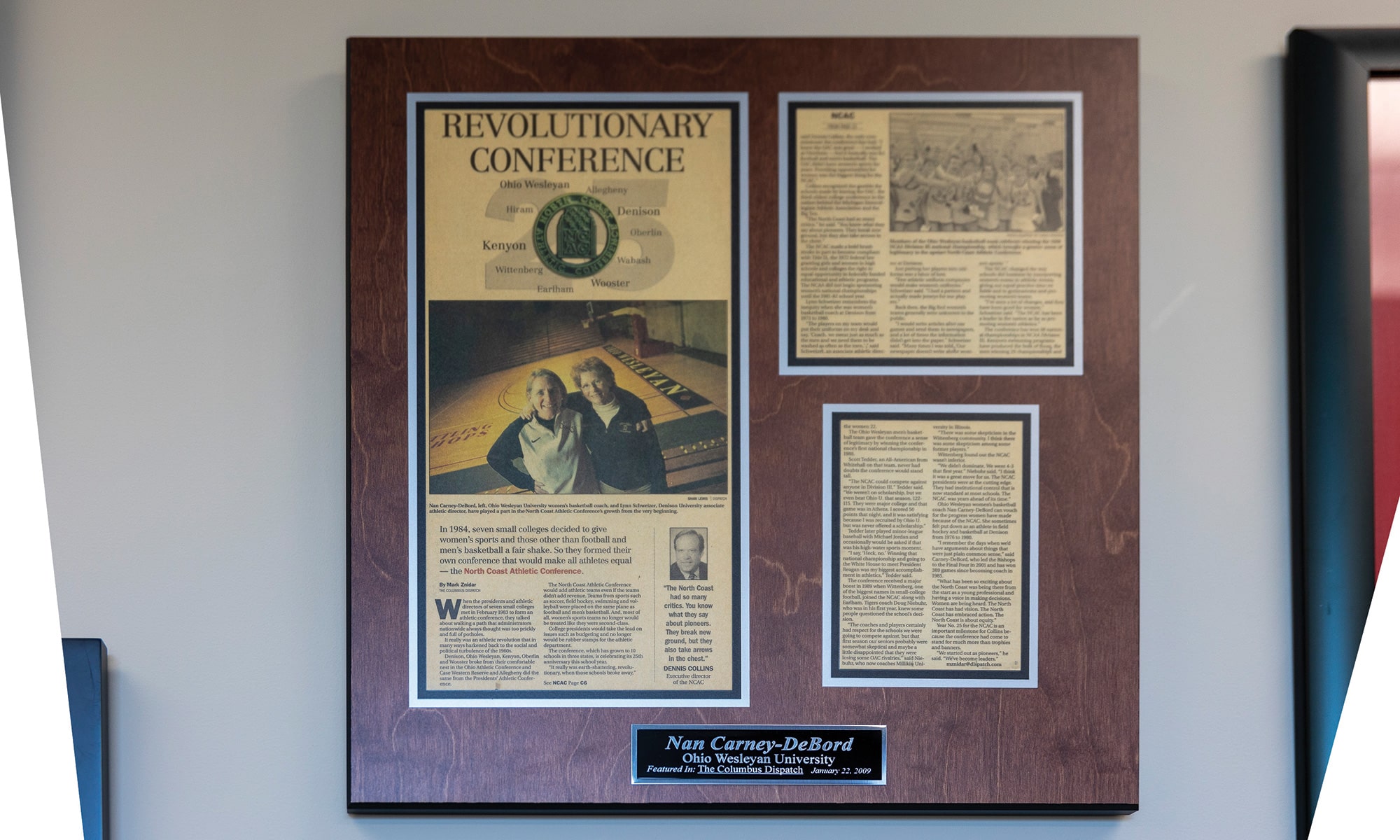 The yellowed newspaper story about the growth of the NCAC with a picture of Carney-DeBord and longtime Denison coach and administrator Lynn Schweizer, arms thrown over each other’s shoulders.