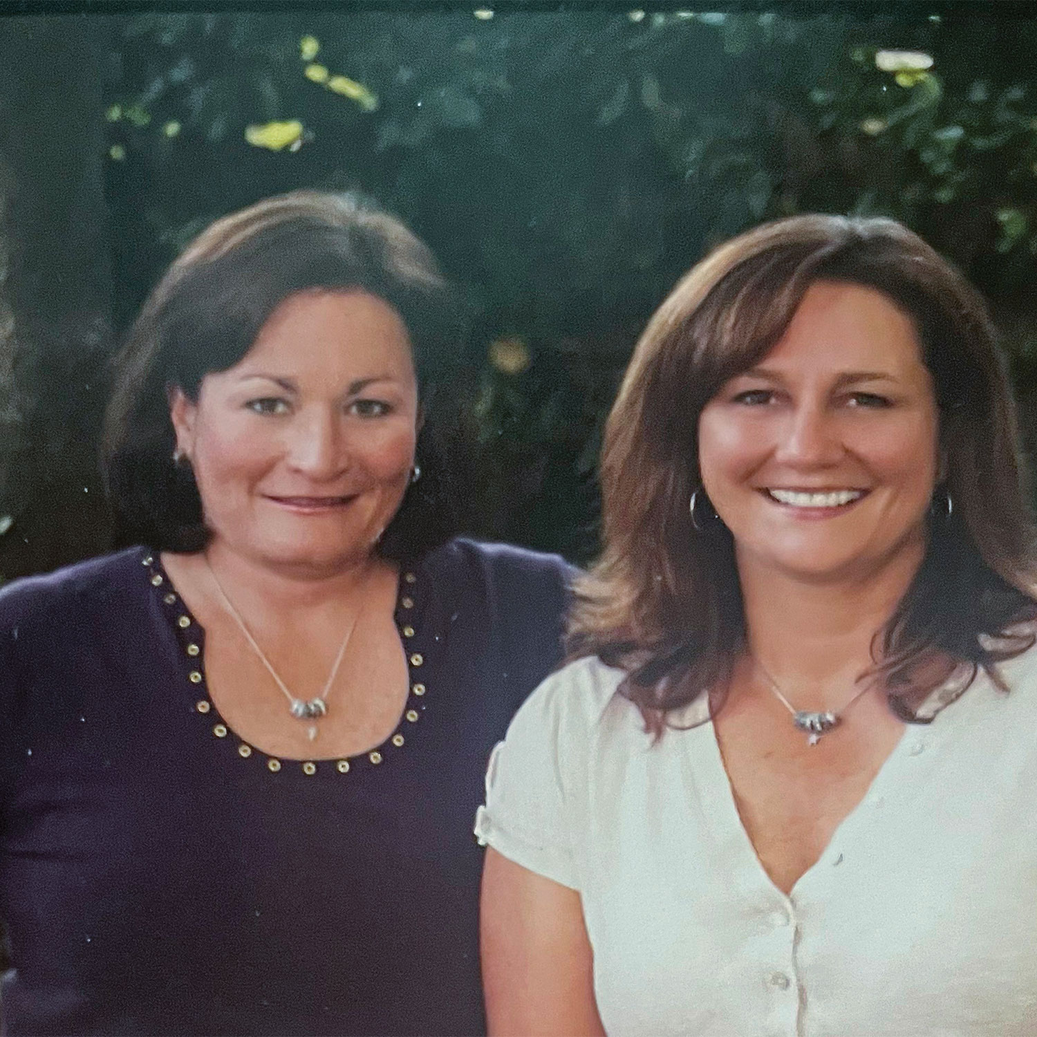 Two women, Katie McConnell Oliver and Monica Weakley, standing beside each other and smiling for the camera