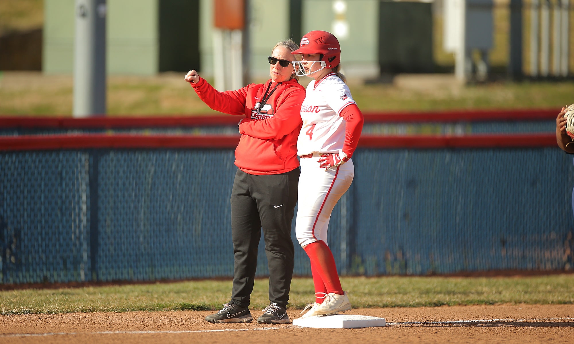 Coach and student on baseball field