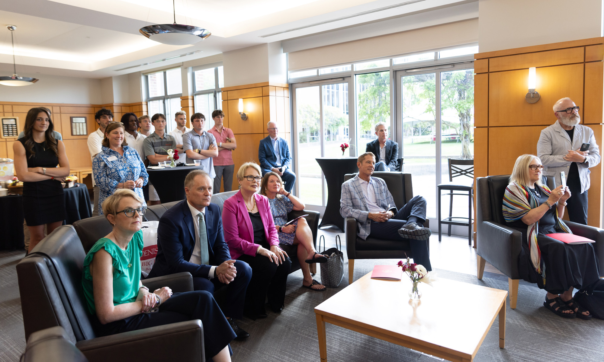The crowd sits and observes a brief commencement ceremony.