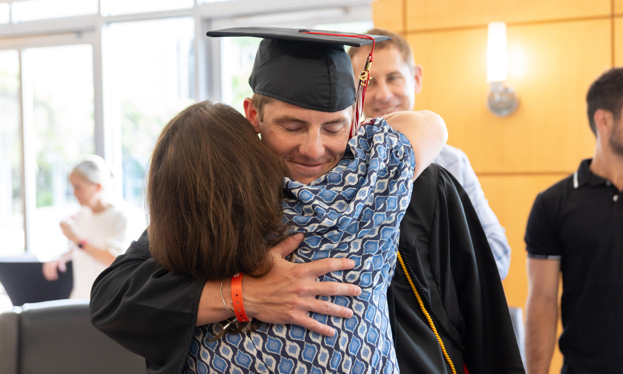 A student embraces a person.