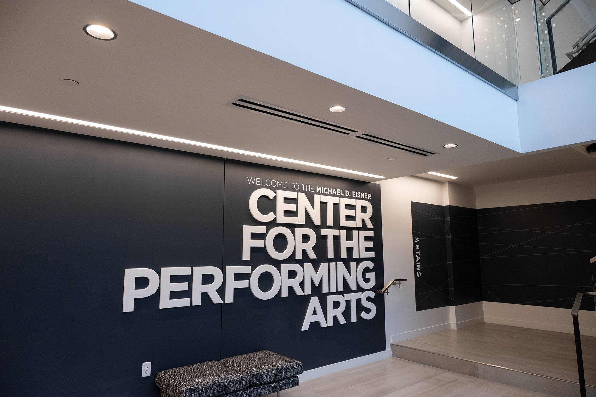 A large wall sign in a modern building that reads "Center for the Performing Arts" in all caps.