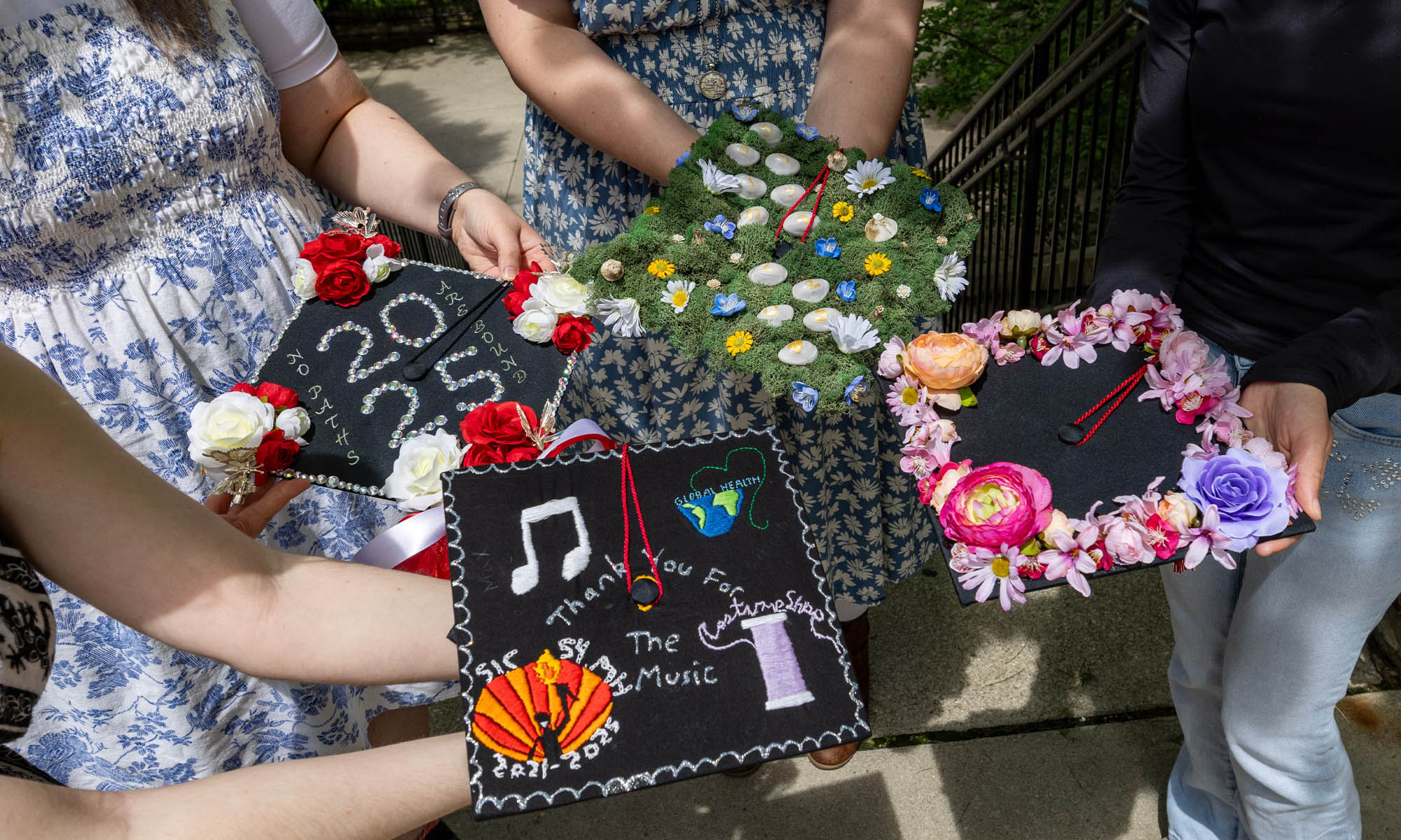 Students display their mortarboards.
