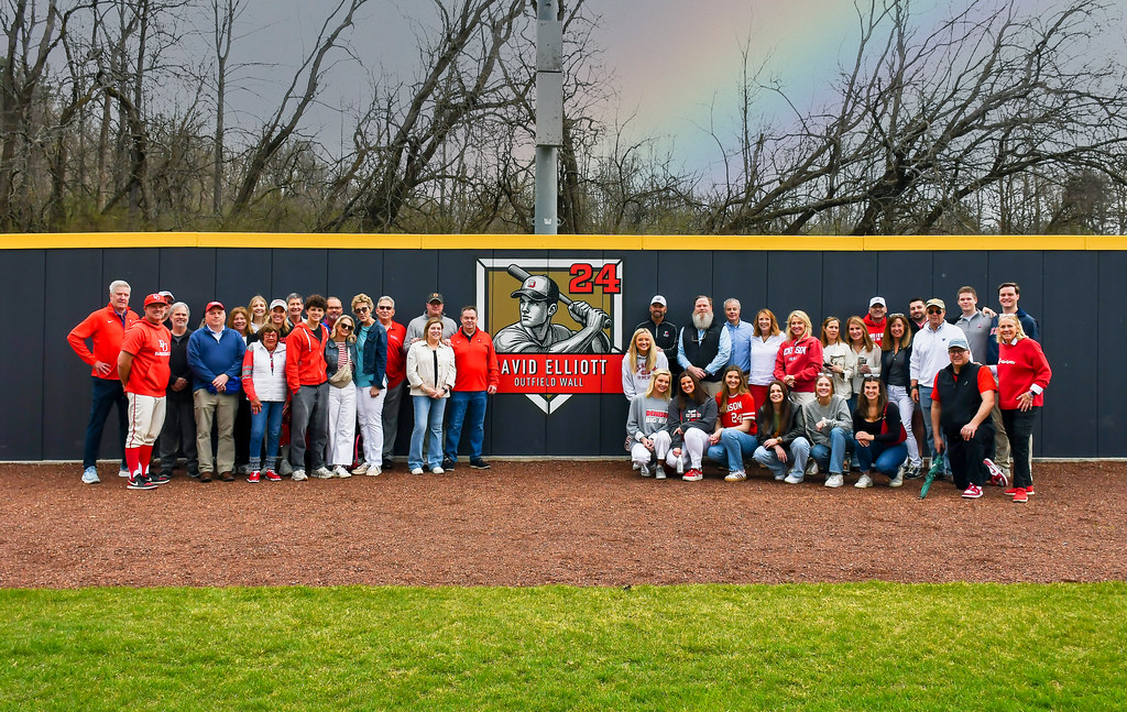 Group posing with the David Elliott Outfield Wall