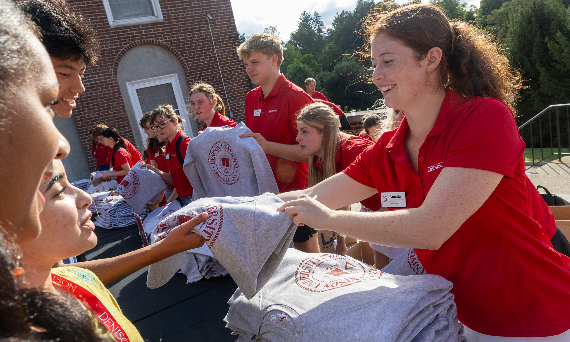 Denison staff hand out sweatshirts to first-year students.