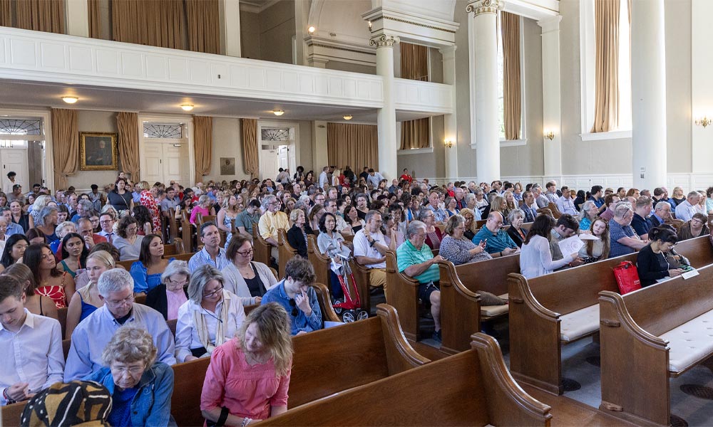 Students and their parents sit in Swasey Chapel.