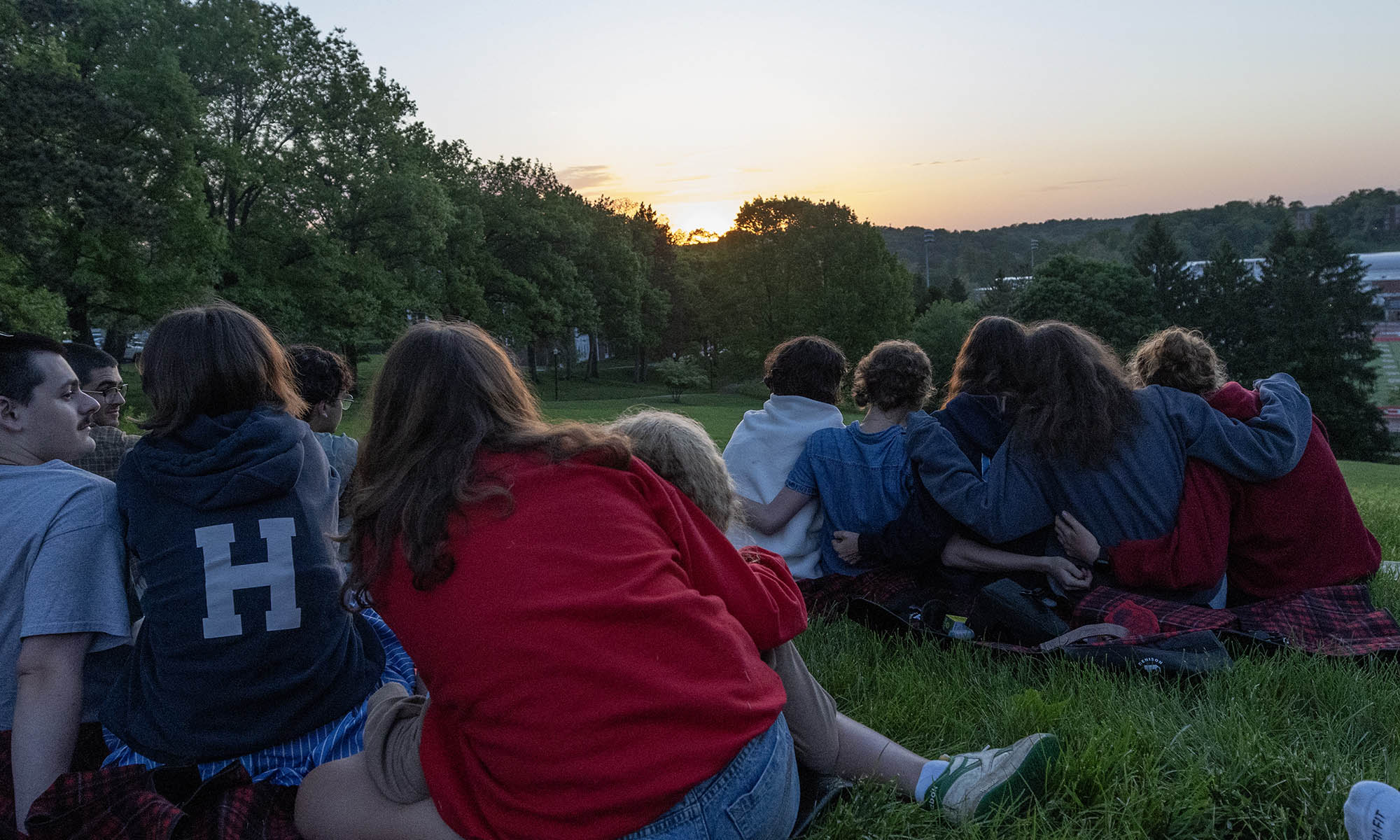 Photo of students looking at sunrise in the distance.