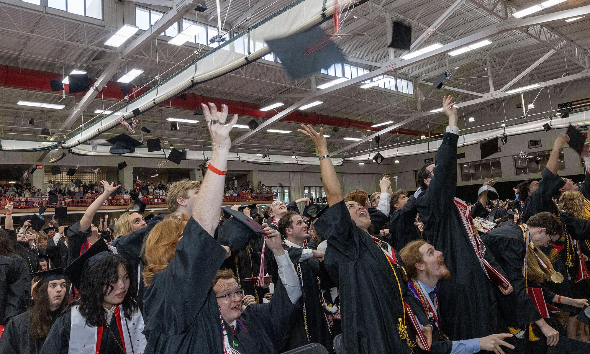 Denison grads toss their caps in the air.