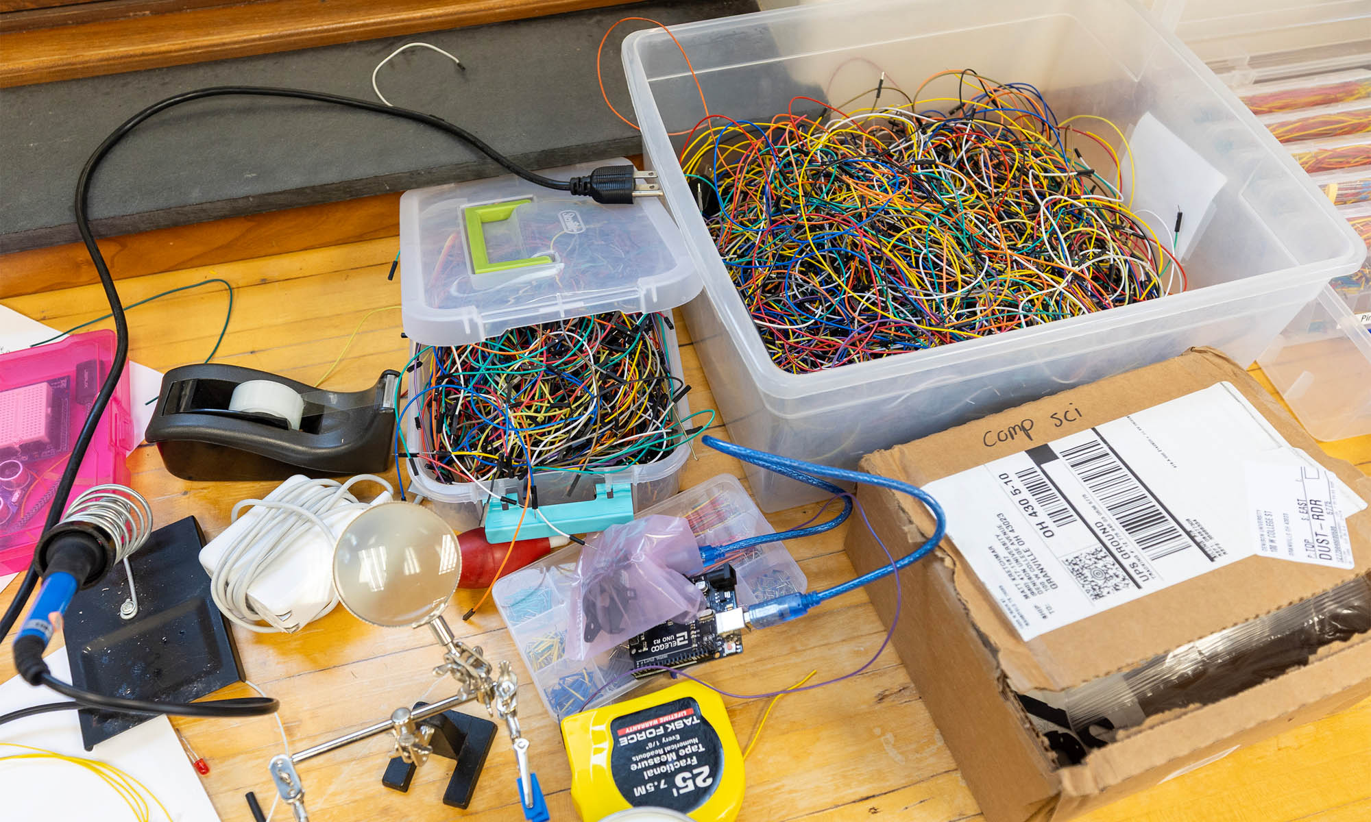 Photo of a lab table covered with various tools and wires.