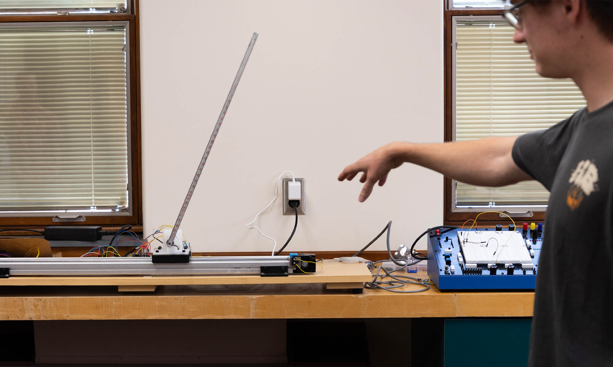 A student working with "Larry" - a robotic inverted pendulum.