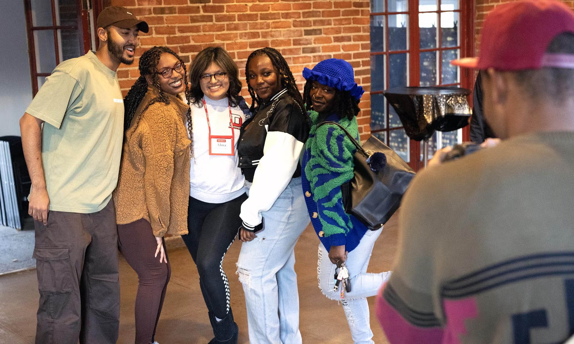 Denison alumni posing for a photographer at alumni event.