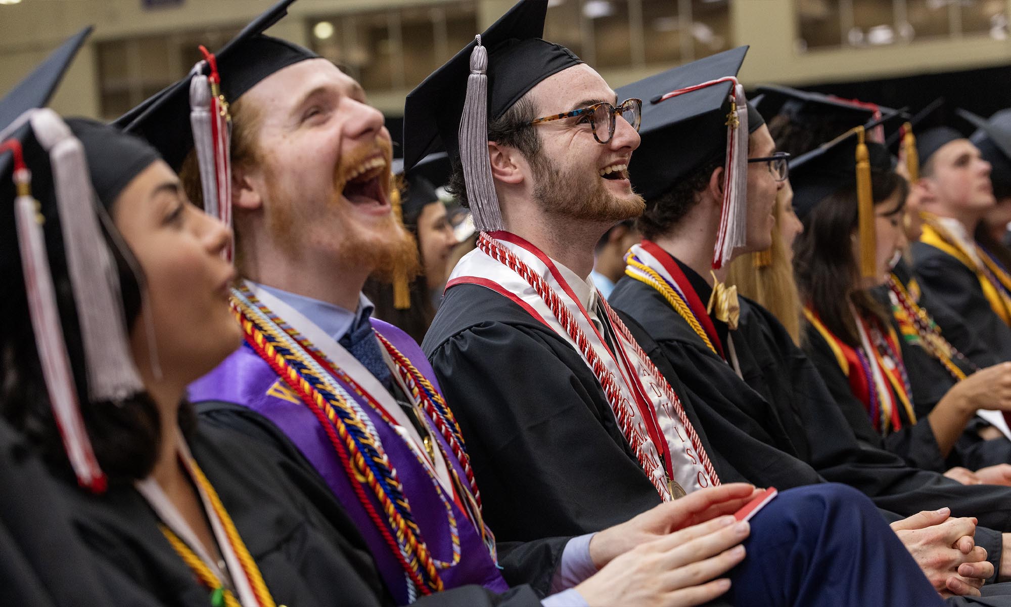 Graduates laughing in response to Steve Carell's message.