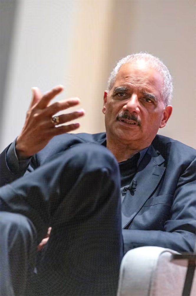Eric H. Holder speaking at an event.