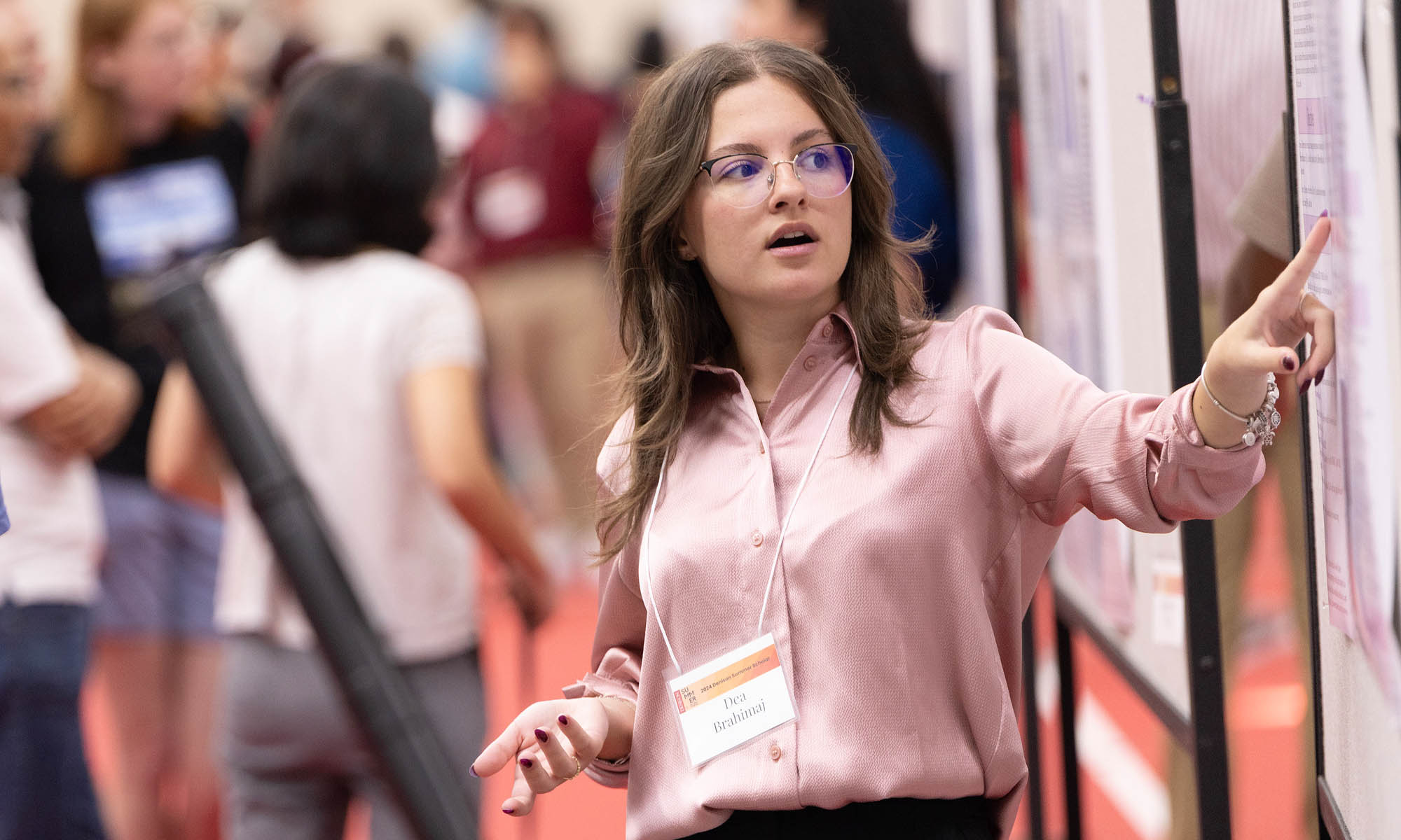 A student presents their research at the annual research symposium.