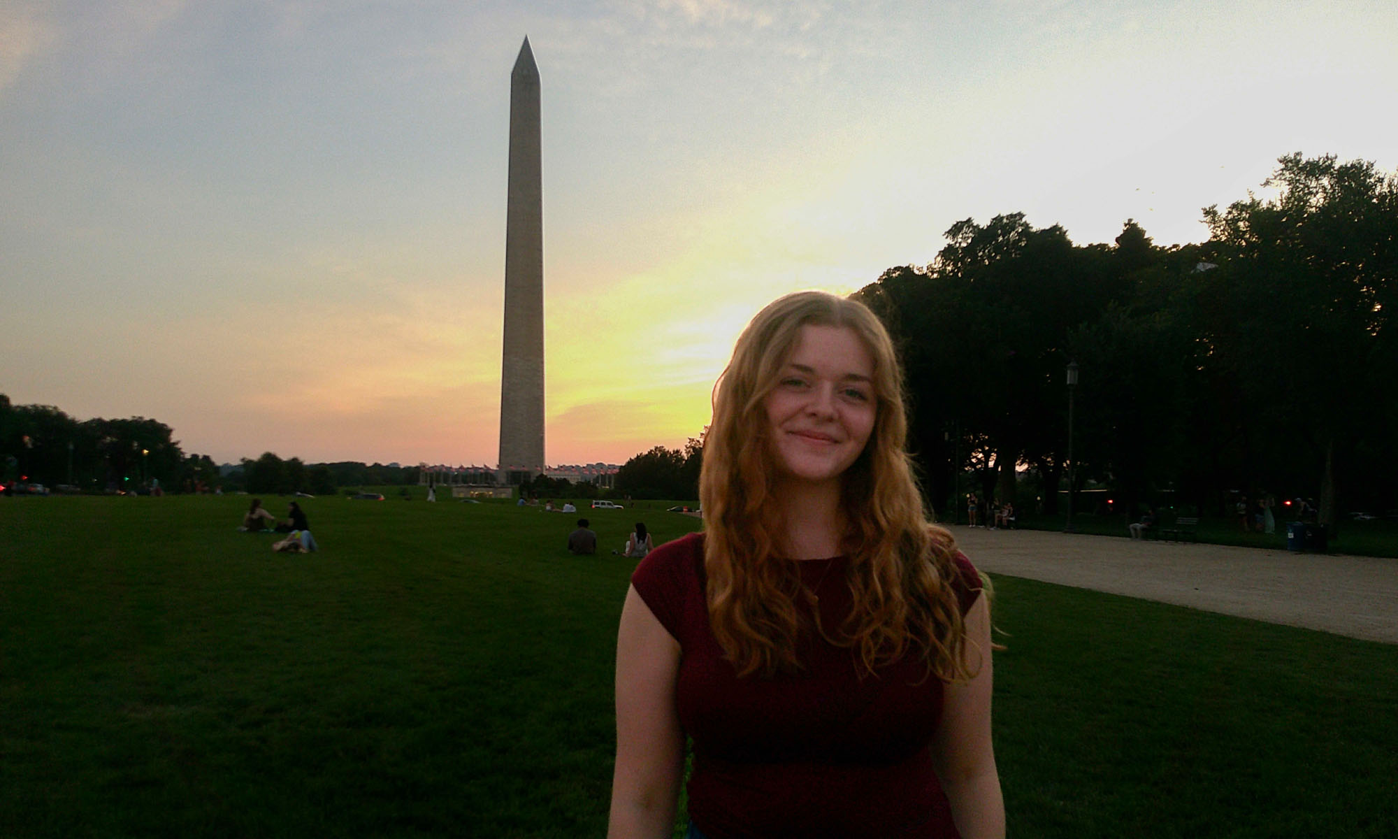 Photo of Julia Smith '28 standing on the National Mall in Washington, D.C at sunset with the Washington Monument in the background.