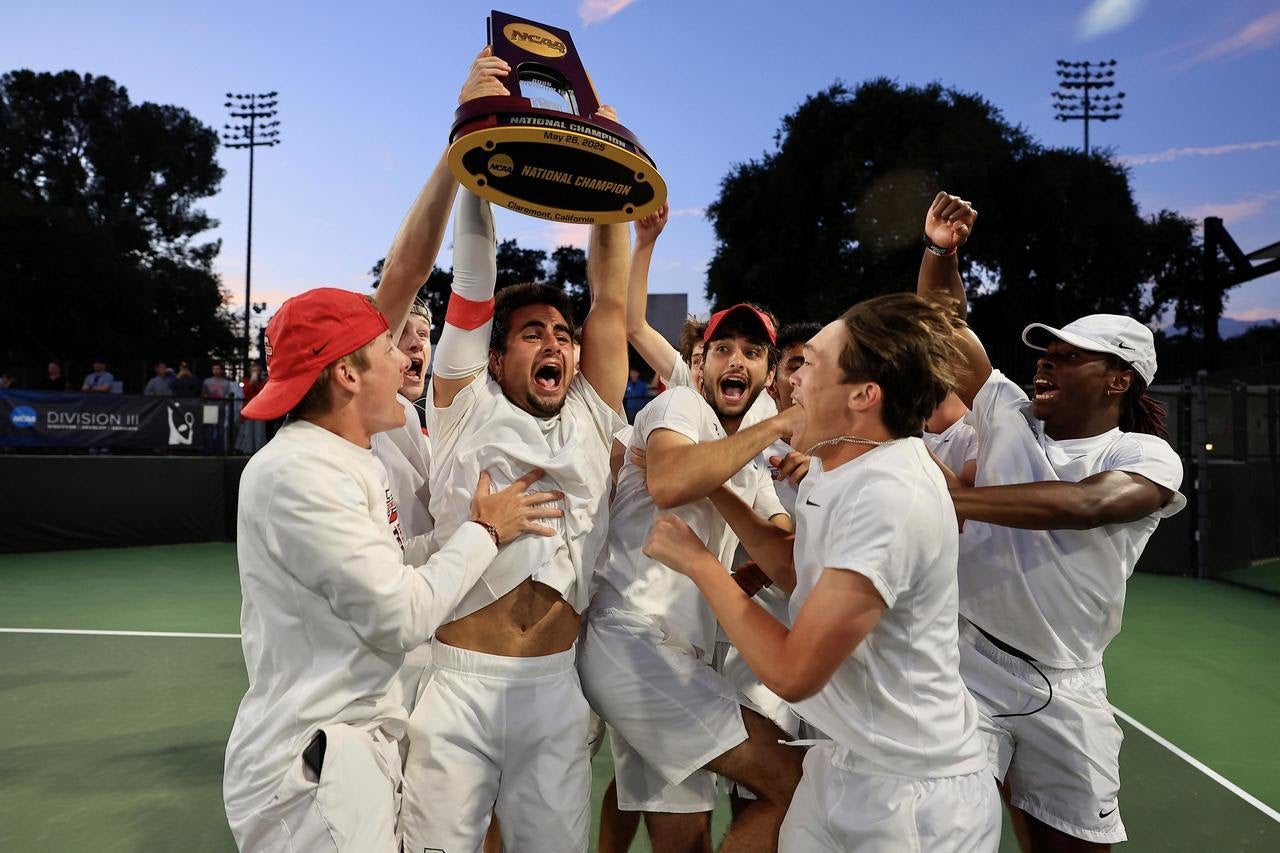 Student athletes cheer and hold up their trophy