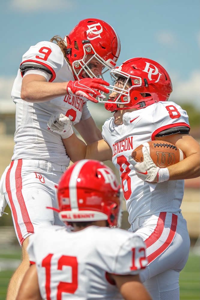 The football team celebrates on the field