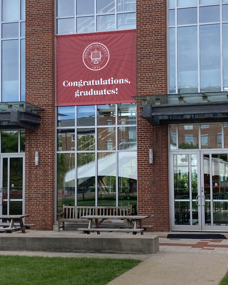 Burton Morgan entrance featuring large red banner that reads "Congratulations, graduates!"