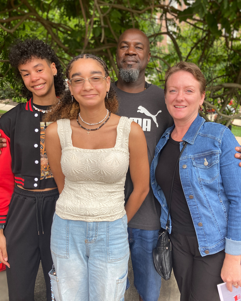 A first-year student and family pose for a portrait at Induction.