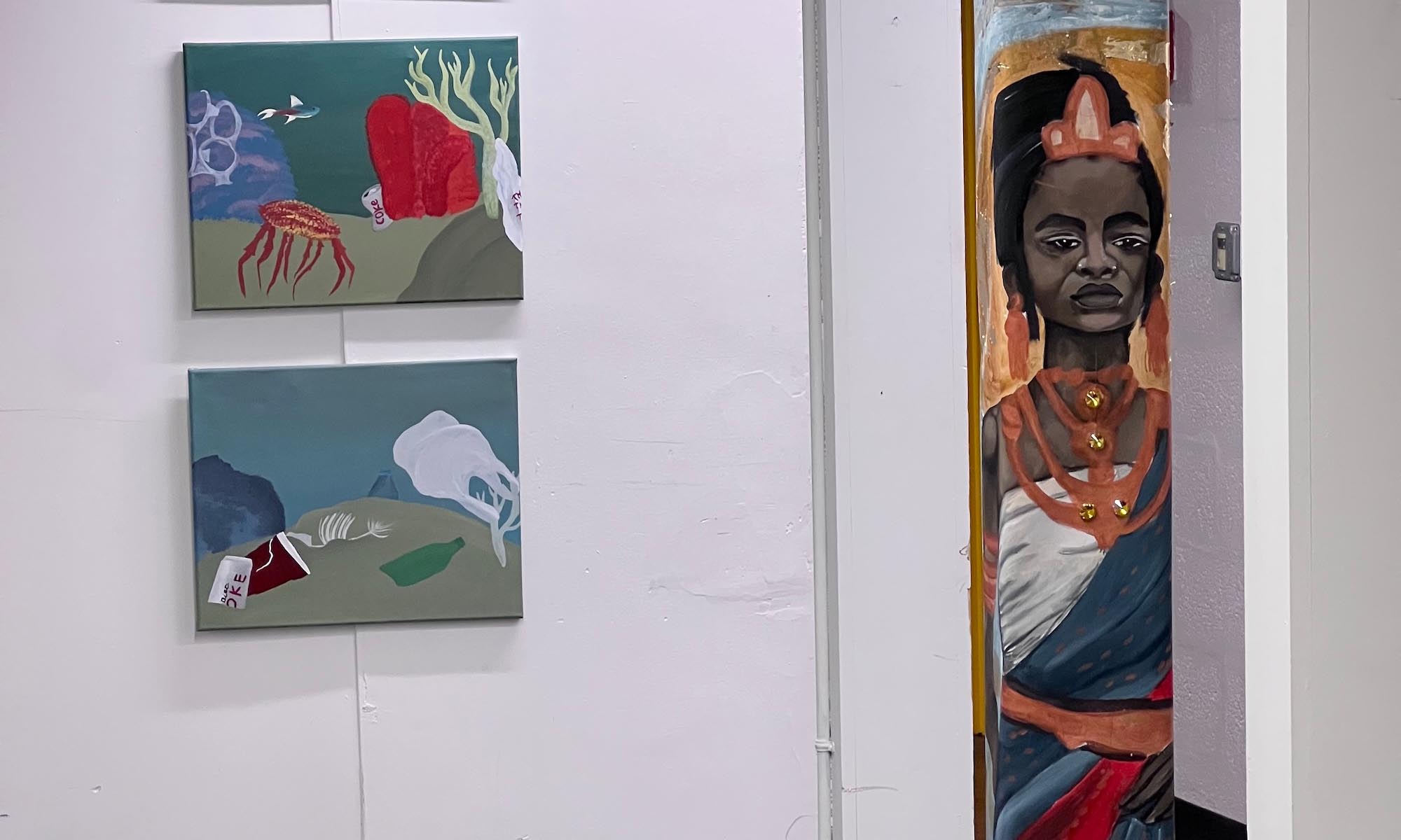 Art displayed on a wall and on a pillar in the Denison Libraries.