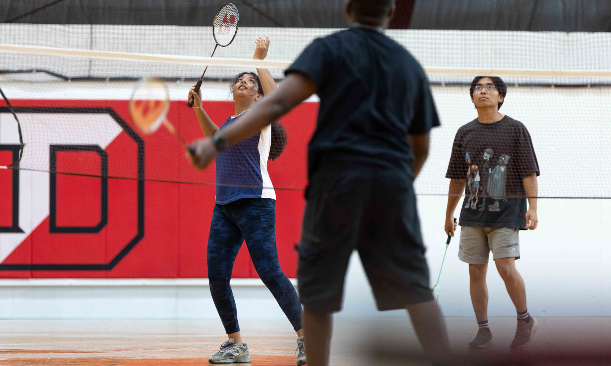 Students play badminton in the Mitchell Center.
