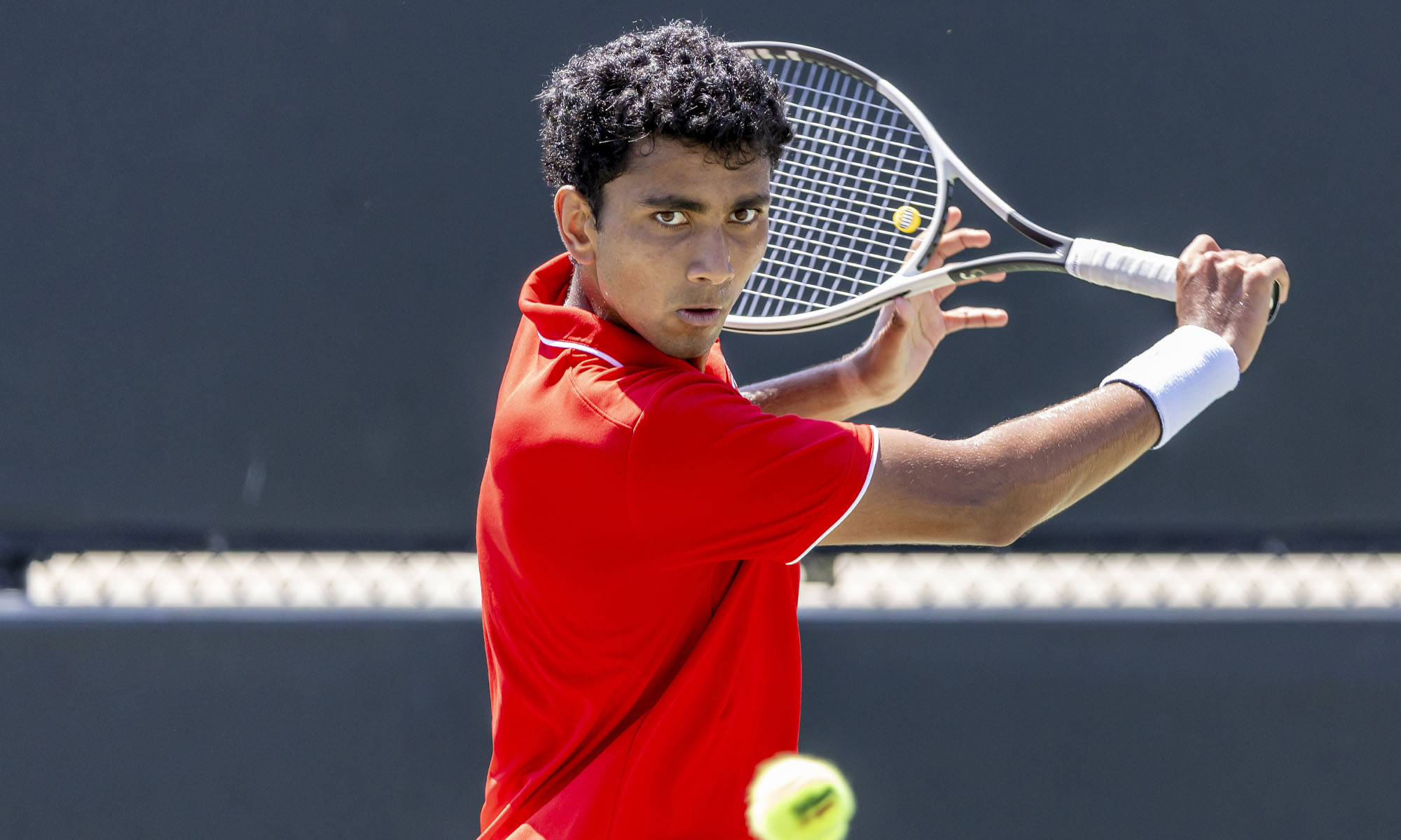 Photo of Kael Shah playing tennis.