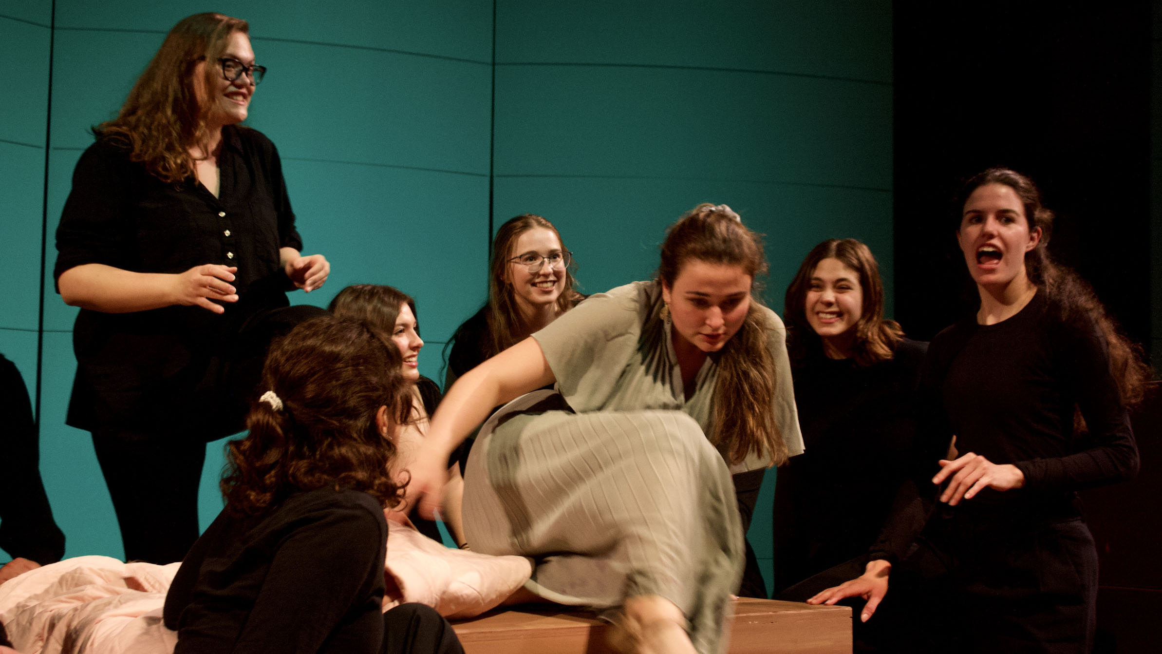 Students perform on stage.