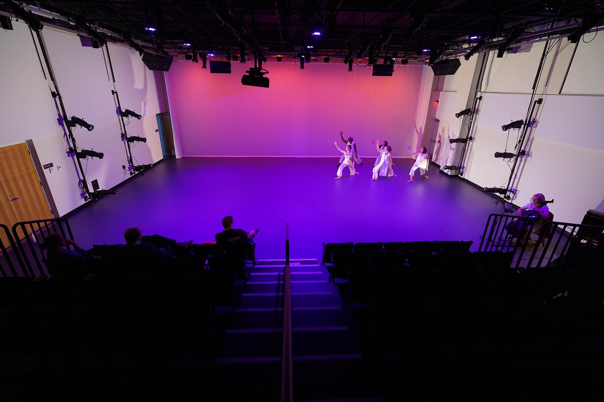 Photo of a dance studio, viewed from back of audience.