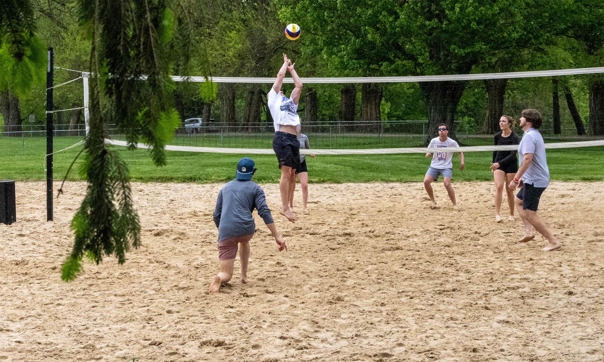 Students playing beach volleyball.