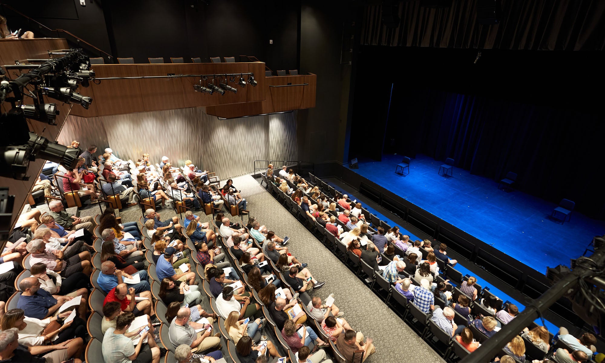 A theatre audience and stage ready for a performance.