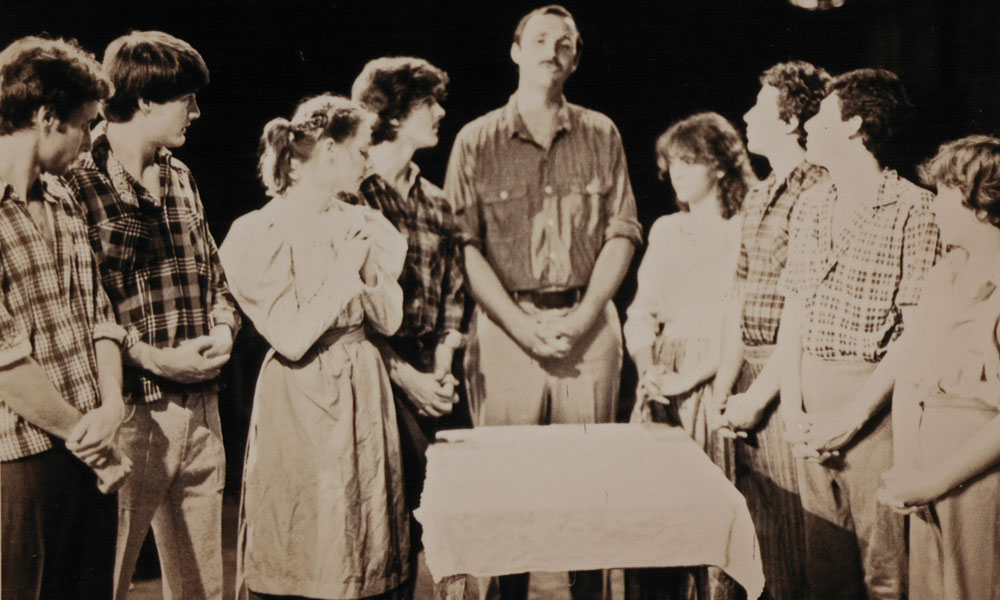 Young Gary with fellow performers on stage.